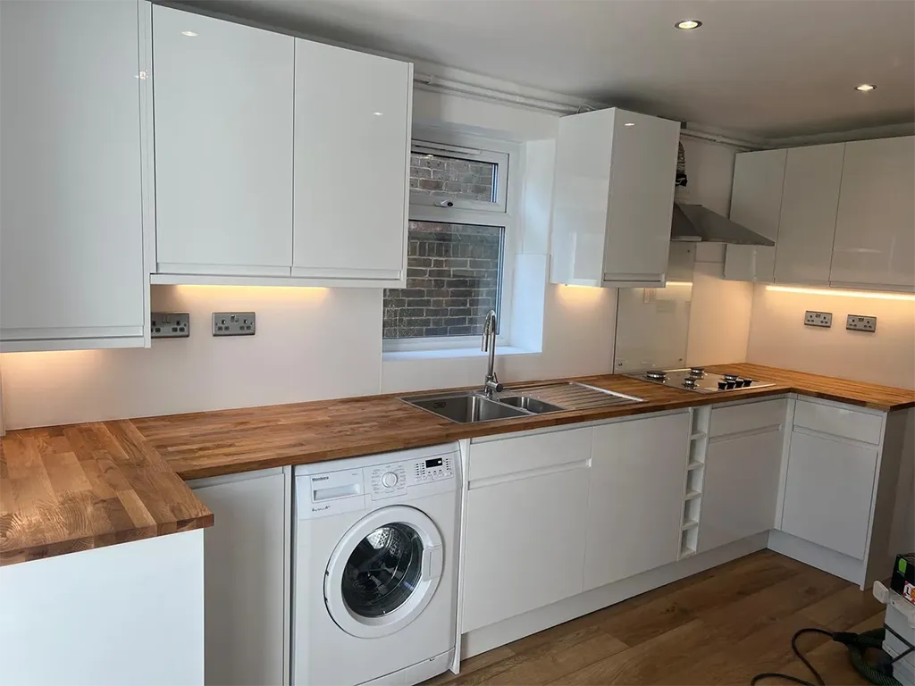 A kitchen with a washer and dryer in it.
