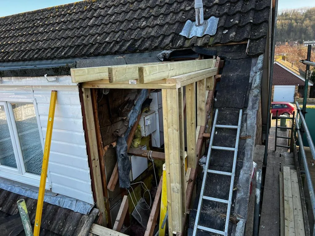 a house being built with a roof that has been torn off